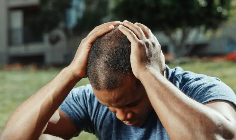 A man holding his head